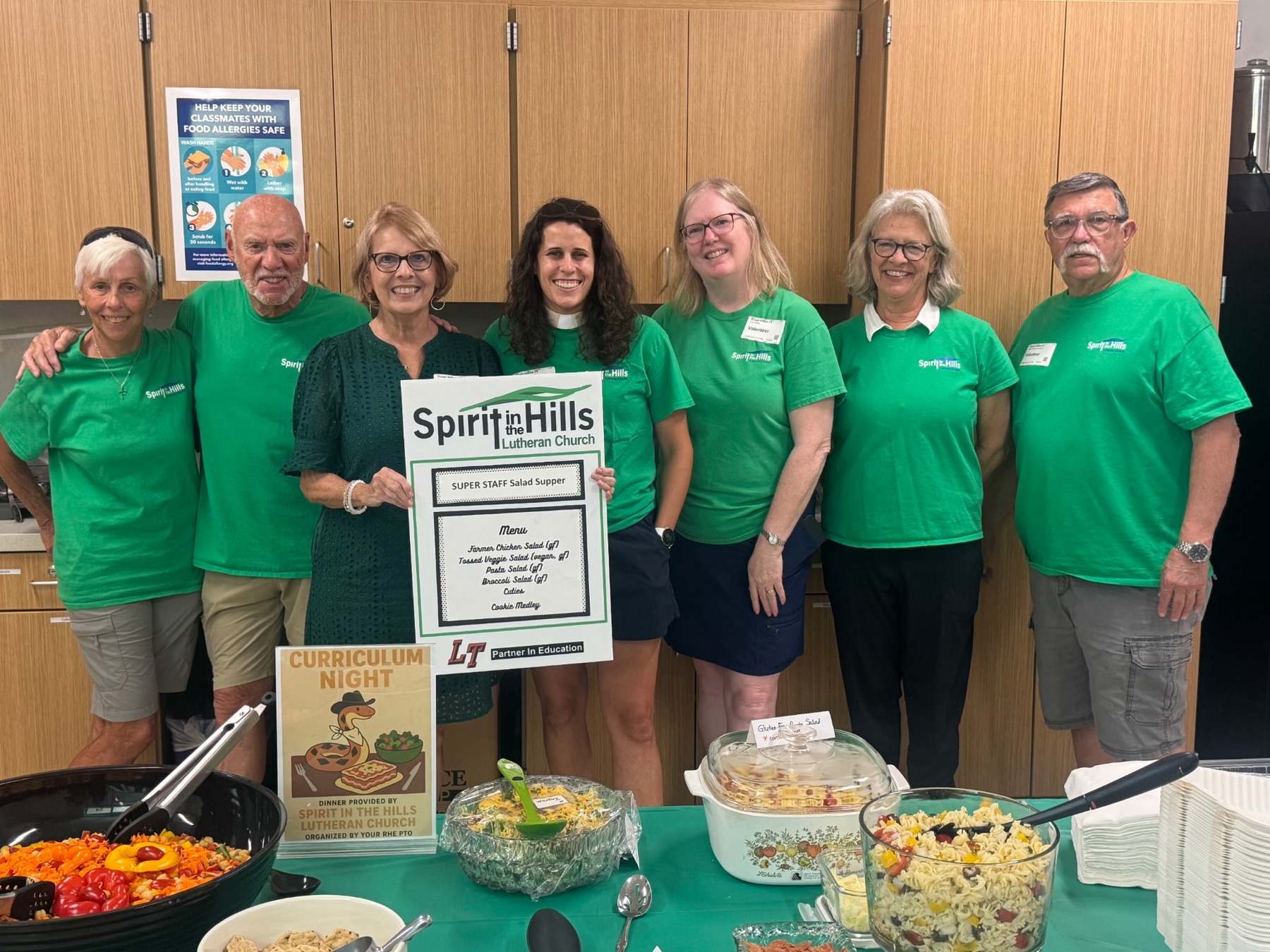 Volunteers in green Spirit in the Hills shirts serving food at a church event
